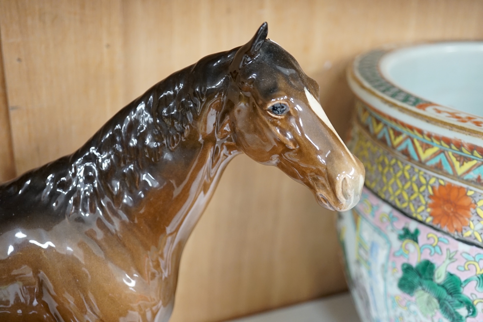 A large Beswick Chestnut horse, together with three other smaller horses and an Exmoor pony, tallest 30cm high (5). Condition - Exmoor pony good, all the others have broken legs or ears